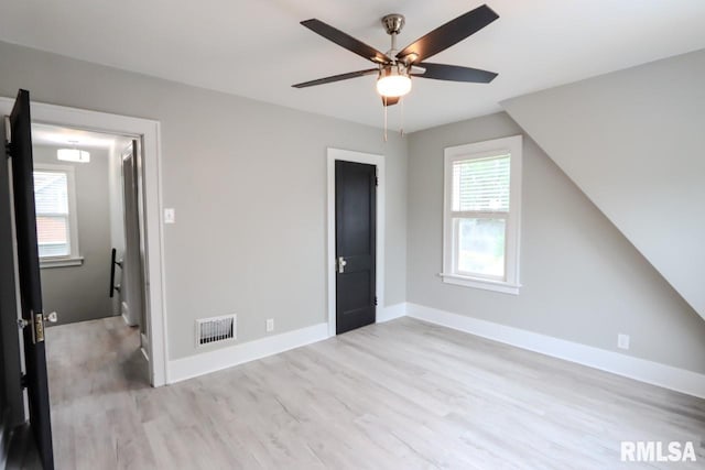 1617 Payson Ave, Quincy, IL 62301 - unfurnished bedroom with wood finished floors, baseboards, and a ceiling fan