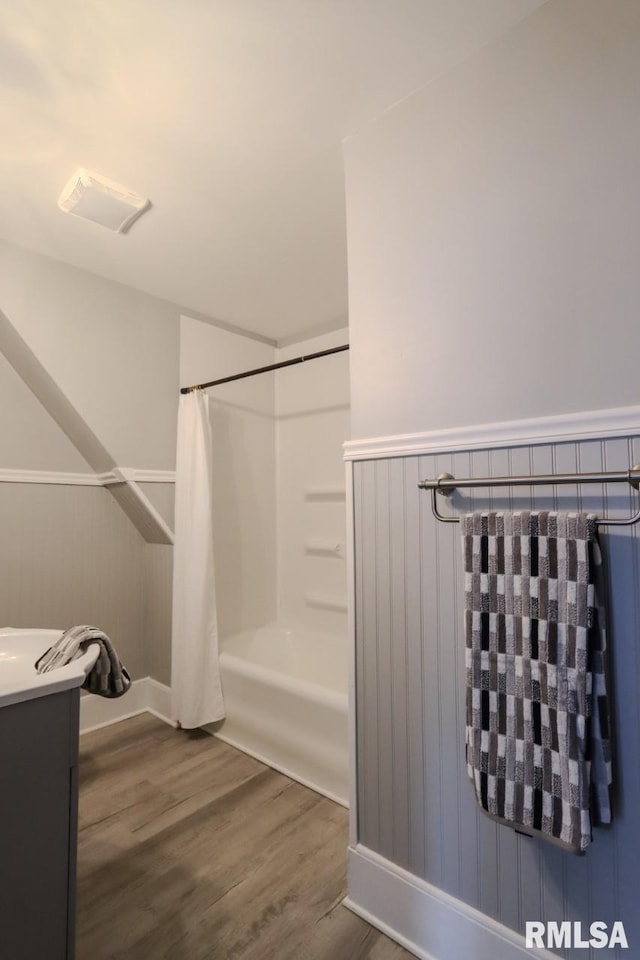 1617 Payson Ave, Quincy, IL 62301 - bathroom with wood finished floors, shower / bathtub combination with curtain, vanity, and baseboards