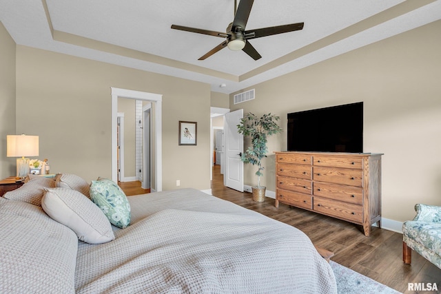 6997 Matthews Pass, Bettendorf, IA 52722 - bedroom featuring wood finished floors, baseboards, a raised ceiling, and ceiling fan