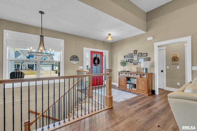 6997 Matthews Pass, Bettendorf, IA 52722 - entrance foyer with dark wood-type flooring, baseboards, and a chandelier