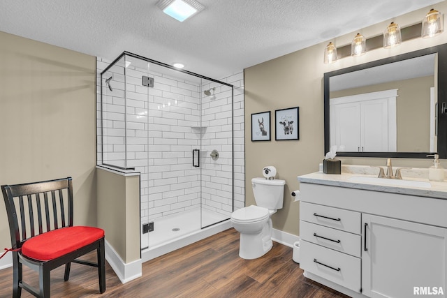 6997 Matthews Pass, Bettendorf, IA 52722 - full bath with vanity, a textured ceiling, toilet, a shower stall, and baseboards