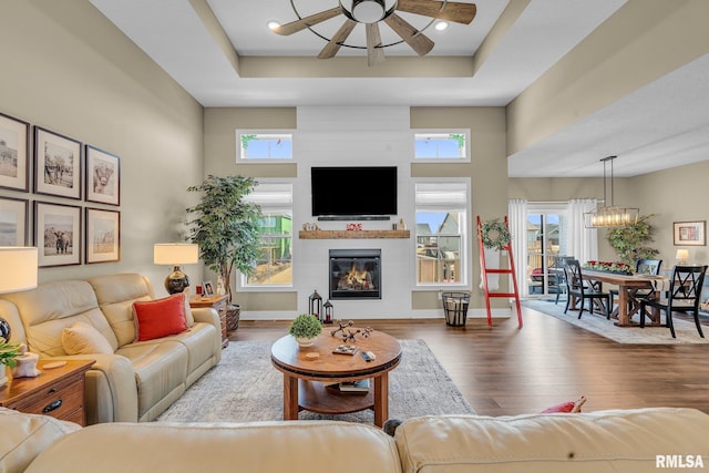 6997 Matthews Pass, Bettendorf, IA 52722 - living room with wood finished floors, ceiling fan, healthy amount of natural light, a large fireplace, and a towering ceiling