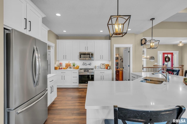 6997 Matthews Pass, Bettendorf, IA 52722 - kitchen with stainless steel appliances, a sink, recessed lighting, decorative light fixtures, and light countertops