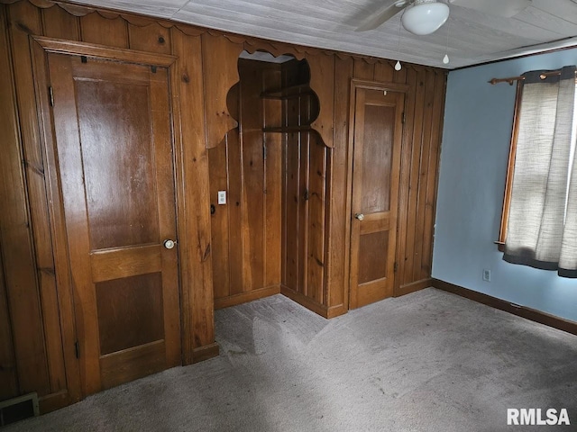 2336 24 1/2 St, Rock Island, IL 61201 - unfurnished bedroom with carpet floors, baseboards, and wood walls