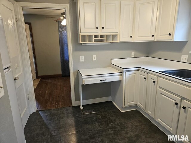2336 24 1/2 St, Rock Island, IL 61201 - kitchen featuring a ceiling fan, white cabinets, light countertops, a sink, and baseboards