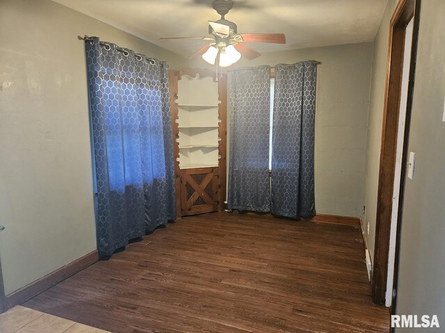 2336 24 1/2 St, Rock Island, IL 61201 - empty room with wood finished floors, ceiling fan, and baseboards