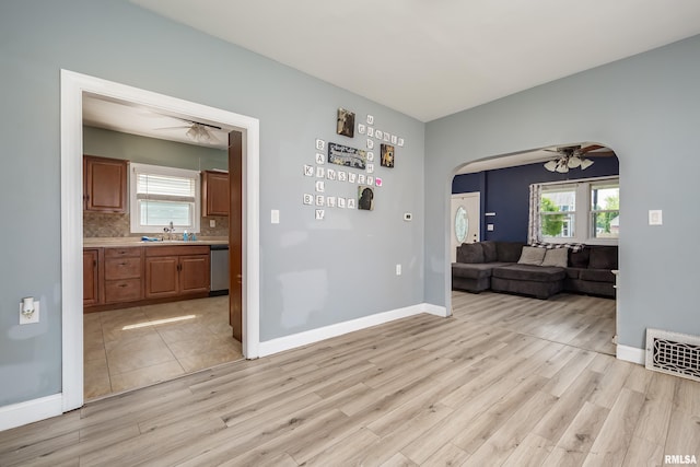 1637 24th Ave, Moline, IL 61265 - living area featuring ceiling fan, light wood-style flooring, arched walkways, and plenty of natural light