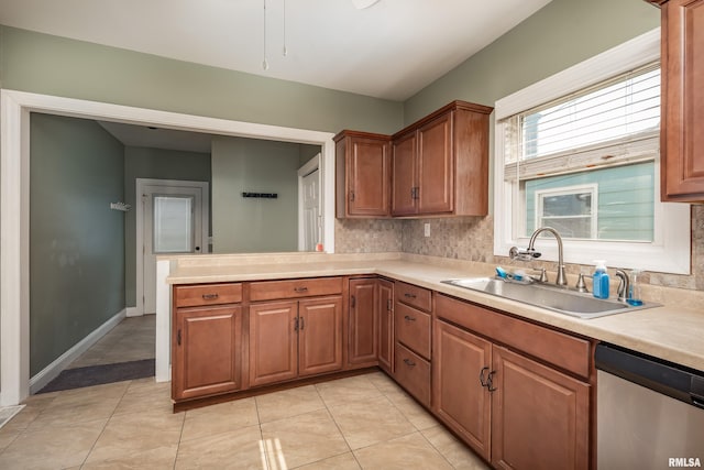 1637 24th Ave, Moline, IL 61265 - kitchen with dishwasher, a sink, light countertops, brown cabinetry, and backsplash
