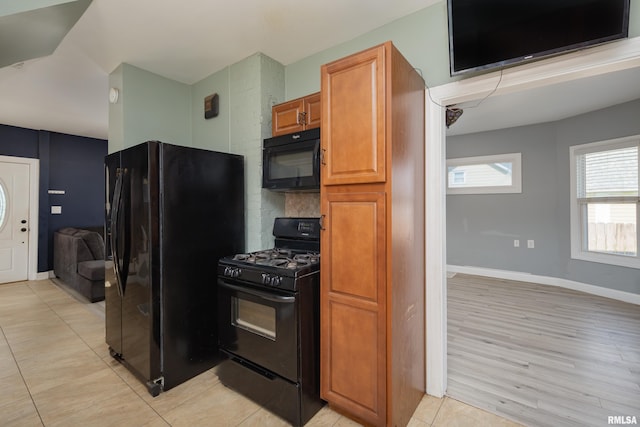 1637 24th Ave, Moline, IL 61265 - kitchen with black appliances, brown cabinets, and baseboards