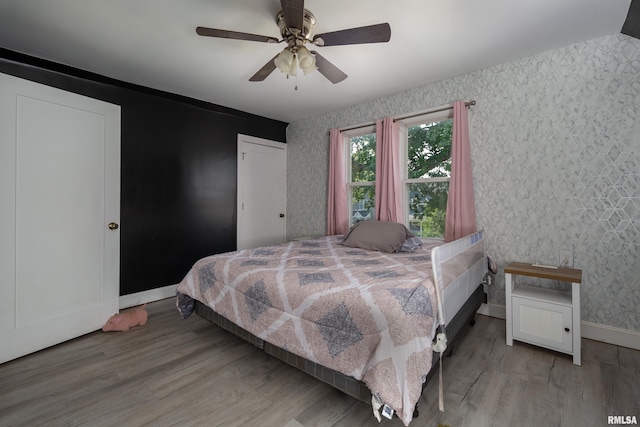 1637 24th Ave, Moline, IL 61265 - bedroom with wallpapered walls, baseboards, wood finished floors, and a ceiling fan