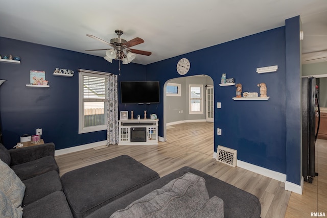 1637 24th Ave, Moline, IL 61265 - living area with ceiling fan, arched walkways, healthy amount of natural light, and wood finished floors