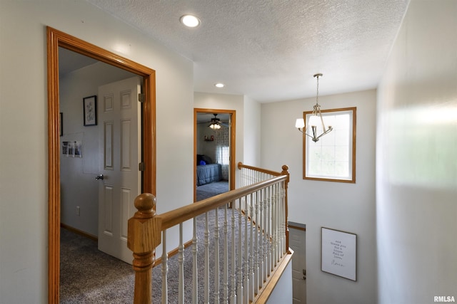 414 11th Avenue A Court, Silvis, IL 61282 - hallway featuring an upstairs landing, carpet, a textured ceiling, baseboards, and recessed lighting