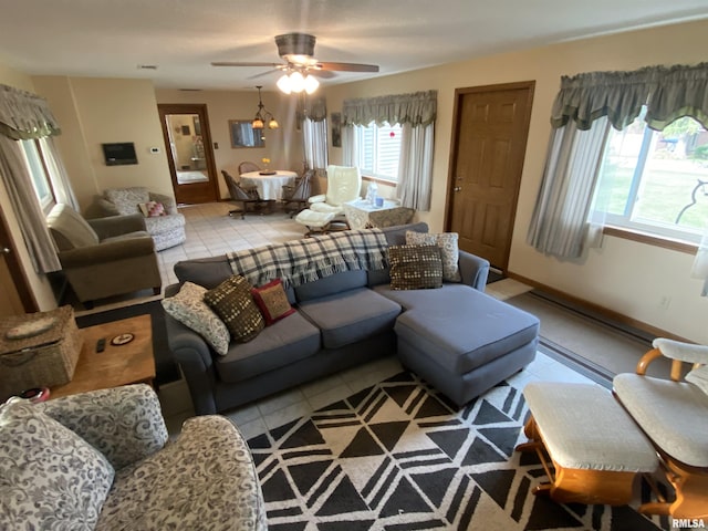 904 W Main St, Reynolds, IL 61279 - living room with light tile patterned floors, healthy amount of natural light, and a ceiling fan