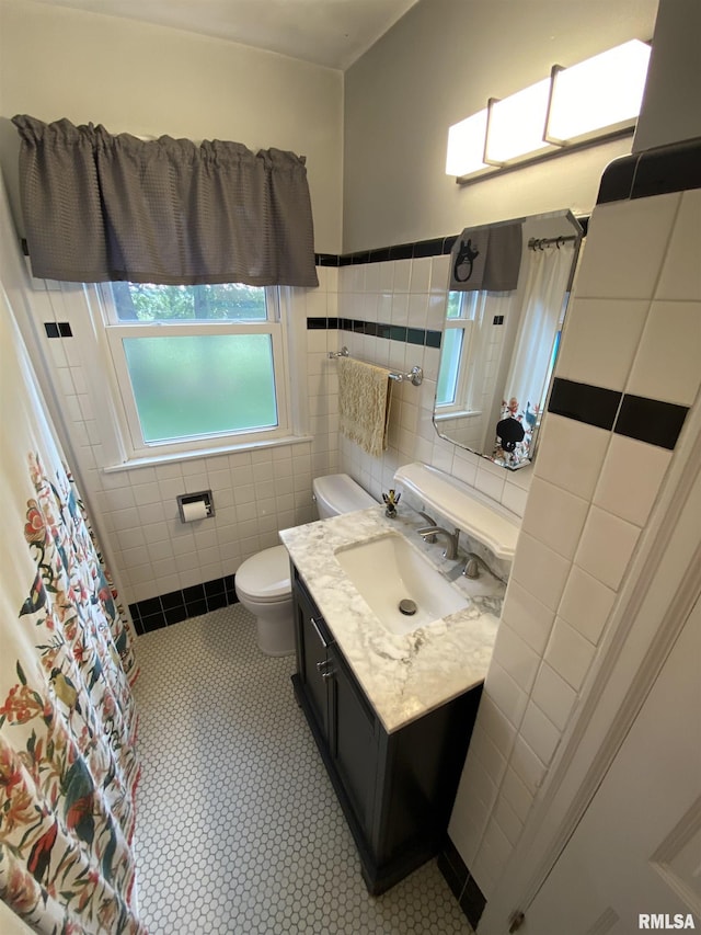 904 W Main St, Reynolds, IL 61279 - bathroom with tile walls, vanity, toilet, a shower with curtain, and wainscoting