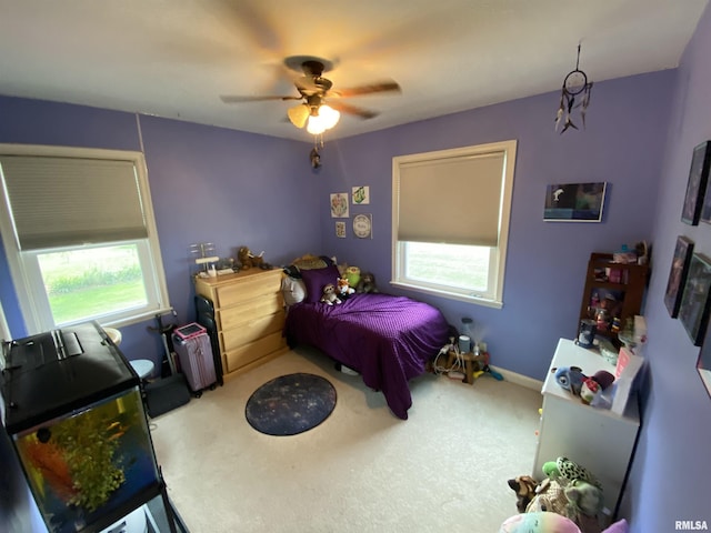 904 W Main St, Reynolds, IL 61279 - carpeted bedroom featuring multiple windows, radiator, baseboards, and ceiling fan