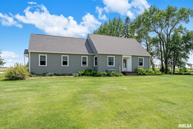 904 W Main St, Reynolds, IL 61279 - cape cod-style house featuring a front lawn, roof with shingles, and cooling unit