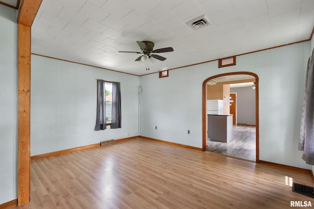 1323 113th Ave, Milan, IL 61264 - empty room featuring arched walkways, wood finished floors, a ceiling fan, baseboards, and ornamental molding