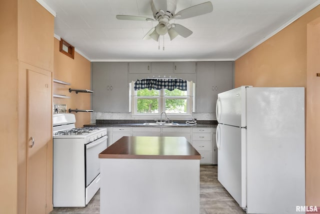 1323 113th Ave, Milan, IL 61264 - kitchen featuring white appliances, a sink, a center island, light wood-type flooring, and ornamental molding
