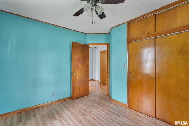 1323 113th Ave, Milan, IL 61264 - unfurnished bedroom with wood finished floors, baseboards, a closet, and ceiling fan