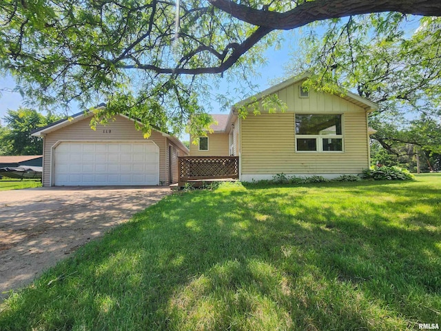 119 9th Ave, Camanche, IA 52730 - view of front of home with an outbuilding, a detached garage, a front yard, and board and batten siding