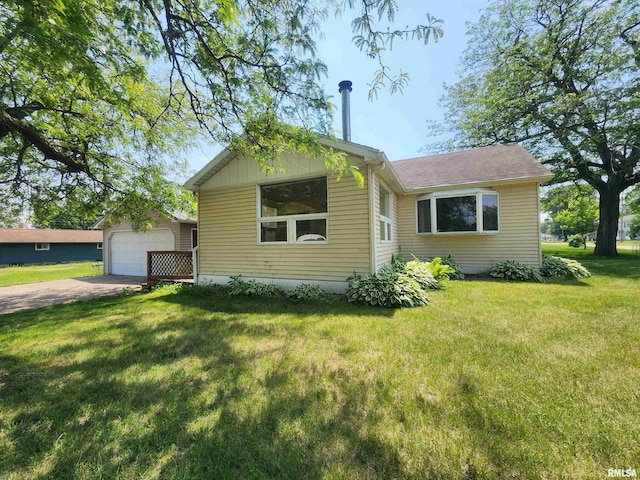 119 9th Ave, Camanche, IA 52730 - bungalow with driveway, an outdoor structure, and a front yard