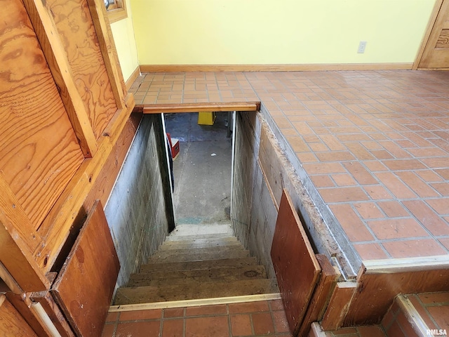 119 9th Ave, Camanche, IA 52730 - stairs with baseboards and brick floors