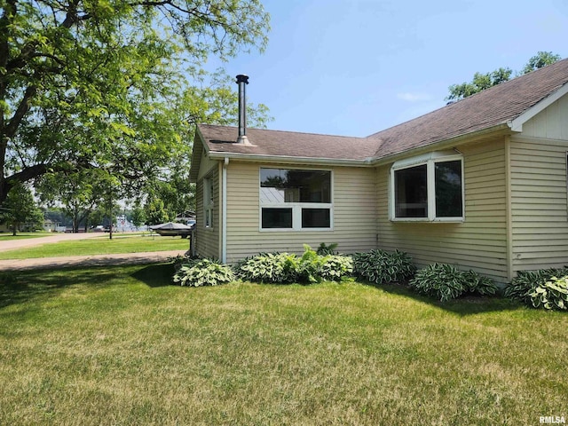 119 9th Ave, Camanche, IA 52730 - view of side of home featuring a lawn and a shingled roof