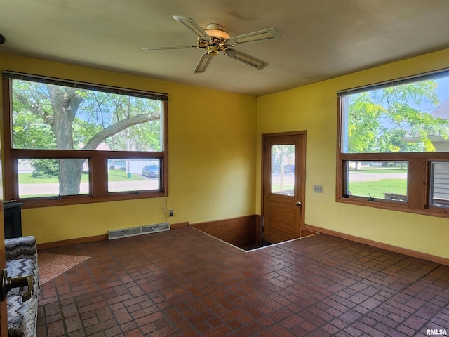 119 9th Ave, Camanche, IA 52730 - foyer entrance featuring brick flooring, ceiling fan, plenty of natural light, and baseboards