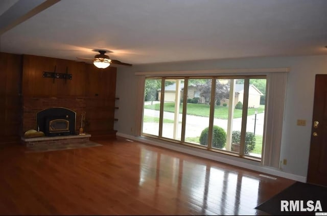 2034 W Wilmar Dr, Quincy, IL 62301 - unfurnished living room featuring baseboards, healthy amount of natural light, wood finished floors, and a ceiling fan