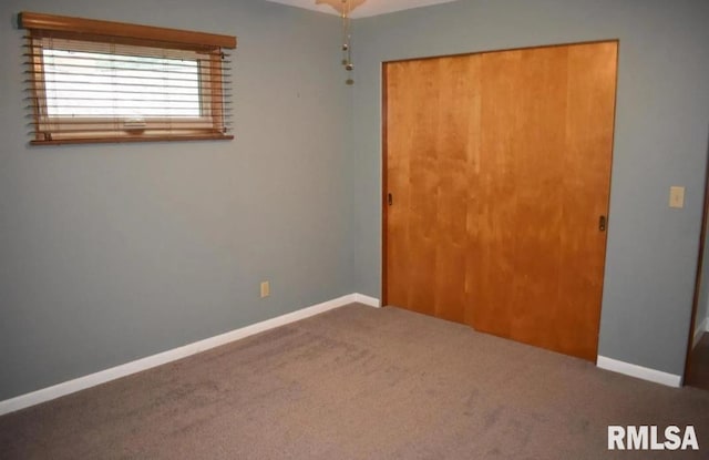 2034 W Wilmar Dr, Quincy, IL 62301 - unfurnished bedroom featuring a closet, carpet, and baseboards