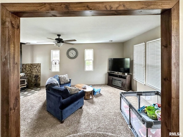 52 Chickasaw St, Mcclure, IL 62957 - carpeted living area with a wood stove and a ceiling fan