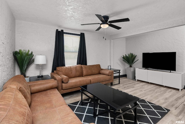 2400 24th St, Rock Island, IL 61201 - living area featuring a textured wall, a textured ceiling, wood finished floors, and a ceiling fan