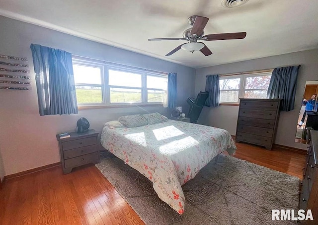 1436 Main Ave, Clinton, IA 52732 - bedroom with wood finished floors, baseboards, and ceiling fan