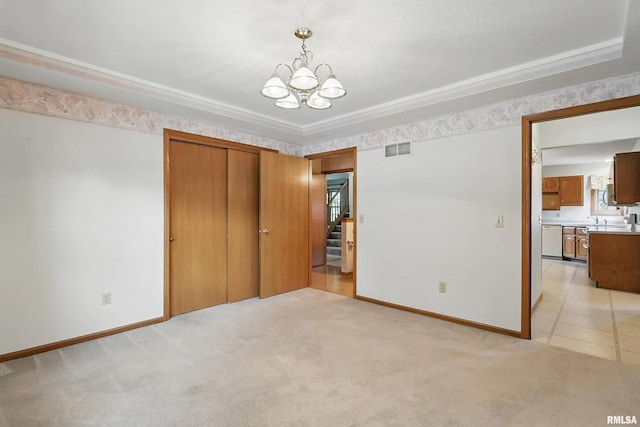 4612 Marquette St, Davenport, IA 52806 - unfurnished bedroom featuring a chandelier, baseboards, light colored carpet, and a closet