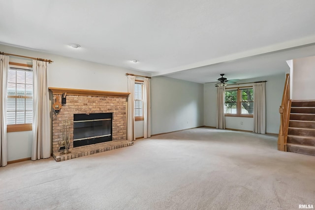4612 Marquette St, Davenport, IA 52806 - unfurnished living room with stairway, a ceiling fan, carpet flooring, a fireplace, and baseboards