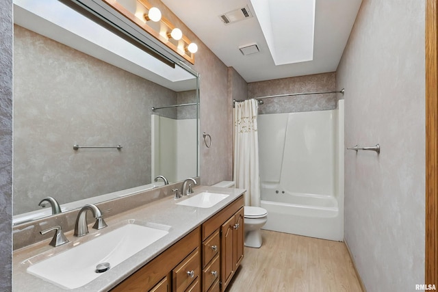 4612 Marquette St, Davenport, IA 52806 - bathroom featuring wood finished floors, shower / bath combo, toilet, and double vanity