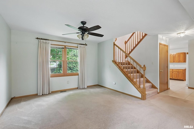4612 Marquette St, Davenport, IA 52806 - unfurnished living room featuring stairway, light colored carpet, a ceiling fan, and baseboards