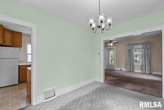 546 21st Ave, Moline, IL 61265 - unfurnished dining area featuring healthy amount of natural light, a chandelier, baseboards, and light carpet