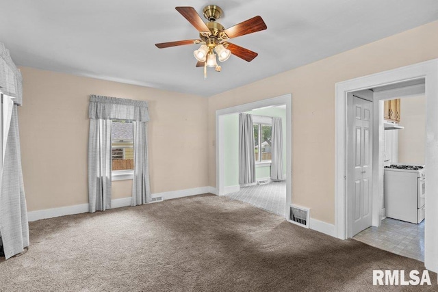 546 21st Ave, Moline, IL 61265 - spare room featuring carpet flooring, a ceiling fan, and baseboards