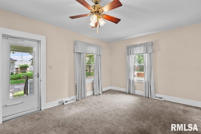546 21st Ave, Moline, IL 61265 - spare room featuring plenty of natural light, carpet, and baseboards