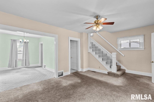 546 21st Ave, Moline, IL 61265 - unfurnished living room with carpet, a chandelier, stairs, ceiling fan, and baseboards