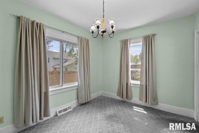 546 21st Ave, Moline, IL 61265 - spare room with a chandelier, carpet floors, and baseboards