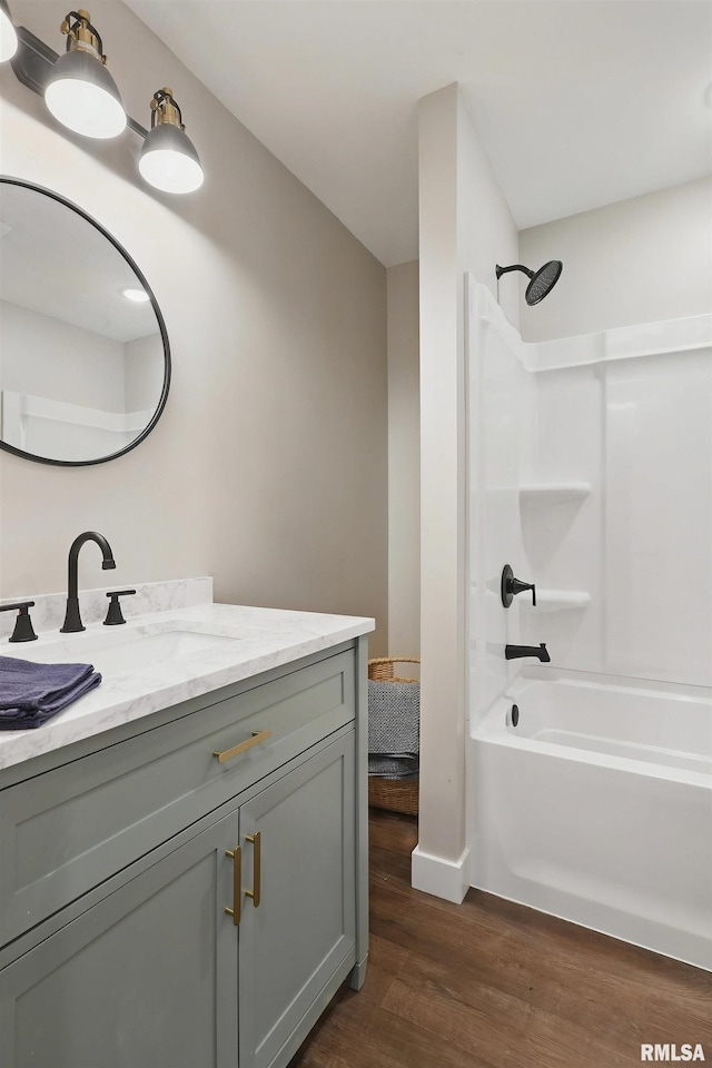 3610 Tam-O-Shanter Dr, Bettendorf, IA 52722 - bathroom featuring wood finished floors, vanity, shower / bathtub combination, and baseboards