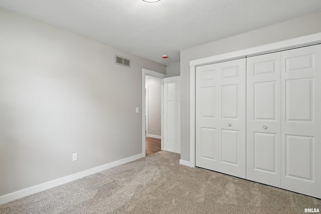 3610 Tam-O-Shanter Dr, Bettendorf, IA 52722 - unfurnished bedroom with carpet, a closet, and baseboards