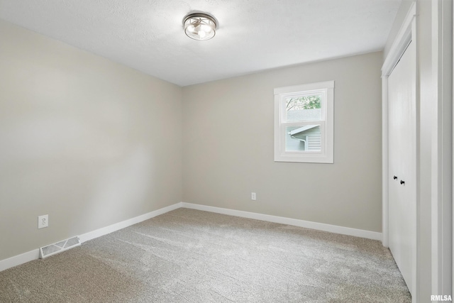 3610 Tam-O-Shanter Dr, Bettendorf, IA 52722 - unfurnished bedroom featuring carpet flooring, a closet, and baseboards