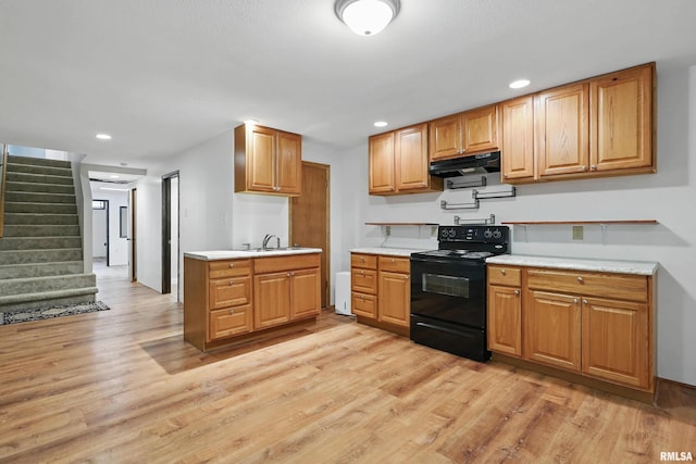 3610 Tam-O-Shanter Dr, Bettendorf, IA 52722 - kitchen featuring black electric range oven, under cabinet range hood, light wood finished floors, light countertops, and recessed lighting