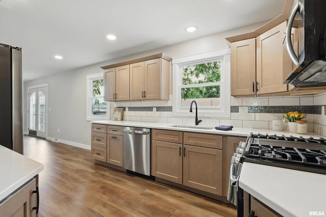 3610 Tam-O-Shanter Dr, Bettendorf, IA 52722 - kitchen with appliances with stainless steel finishes, a sink, healthy amount of natural light, decorative backsplash, and recessed lighting
