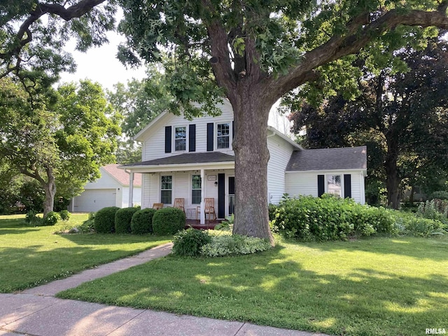 706 N Main St, Port Byron, IL 61275 - view of front of property with covered porch, a front yard, and a garage
