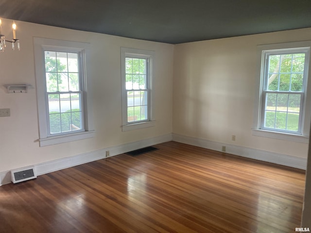 706 N Main St, Port Byron, IL 61275 - spare room with wood finished floors, healthy amount of natural light, and a chandelier