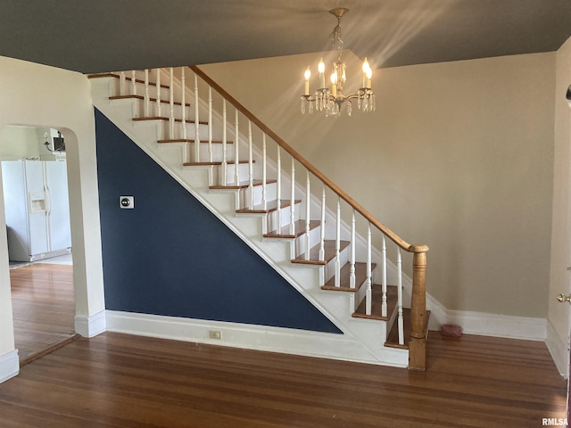 706 N Main St, Port Byron, IL 61275 - staircase with wood finished floors and a chandelier